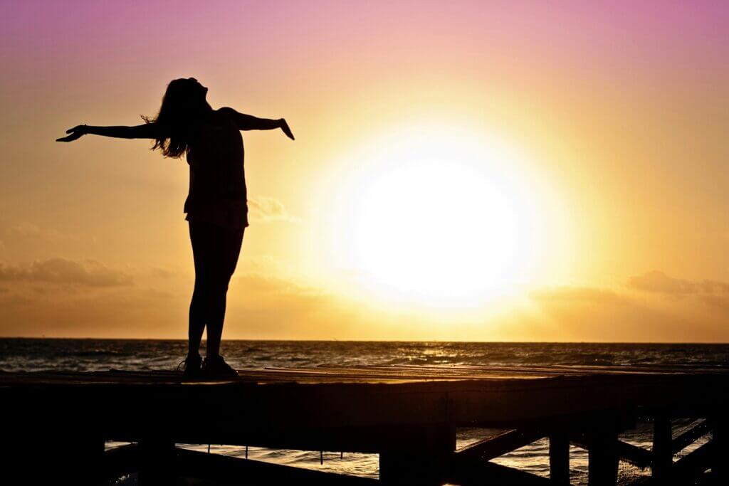 A woman feeling like she "has it all". She is standing on a pier facing the sunset. Find the healthier happier you. Brainspotting and IFS can help integrate stuck emotions so that you're on your way to finding happiness. Therapy provided in North and South Carolina. 