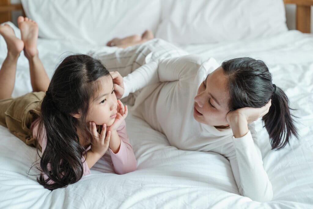 Mom and child are together communicating about their feelings. Mom is validating the child's experience of feeling sad, angry, upset, or afraid. The chid initially had big feelings and big emotions over something. The mom is listening without judgement. 