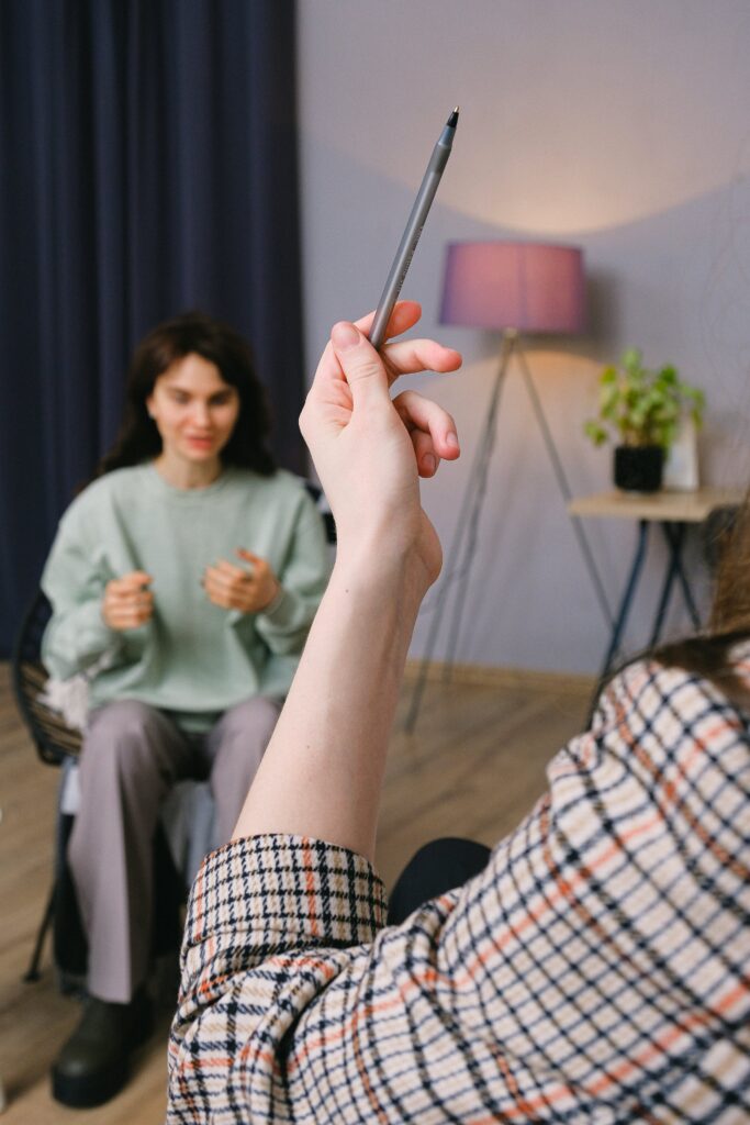 A therapist is using a pointer during a brainspotting session with a client in Matthews, NC. Brainspotting can help with multiple presenting concerns such as anxiety, trauma, depression, grief, and early childhood traumas. 