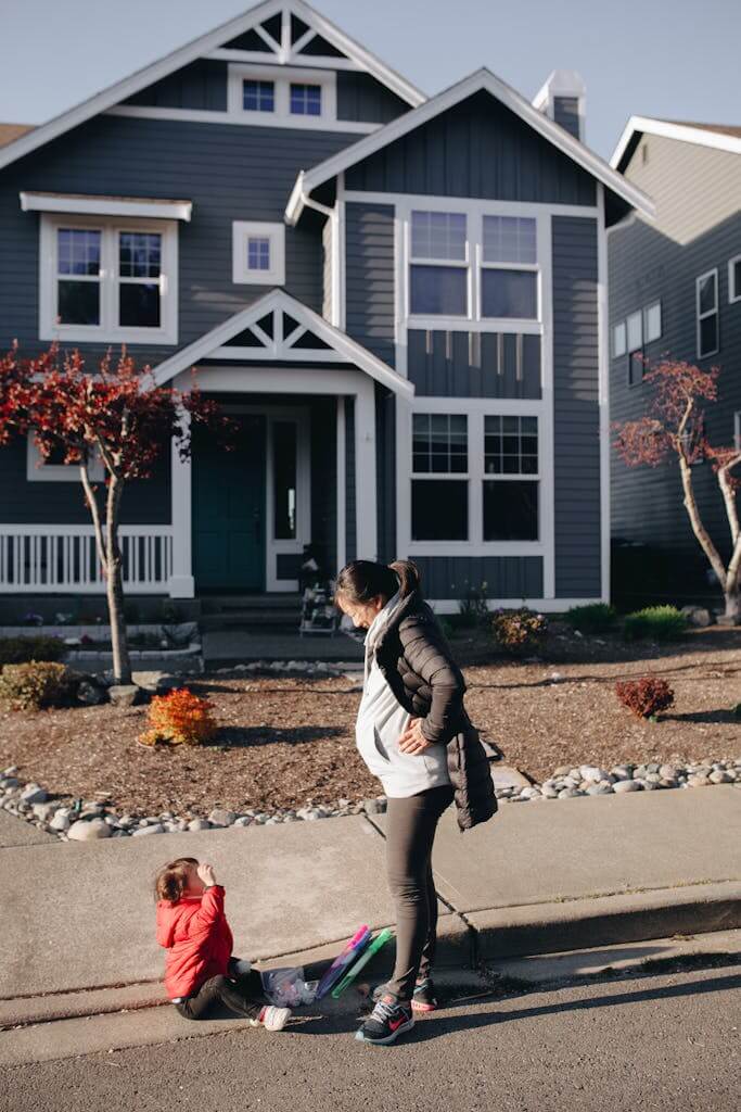 A Child Sitting On Sidewalk Crying Beside Her Mother who is overwhelmed by the stress of parenting. Parents who feel overwhelmed in North Carolina and South Carolina can benefit from Parenting Therapy. Reach out today!