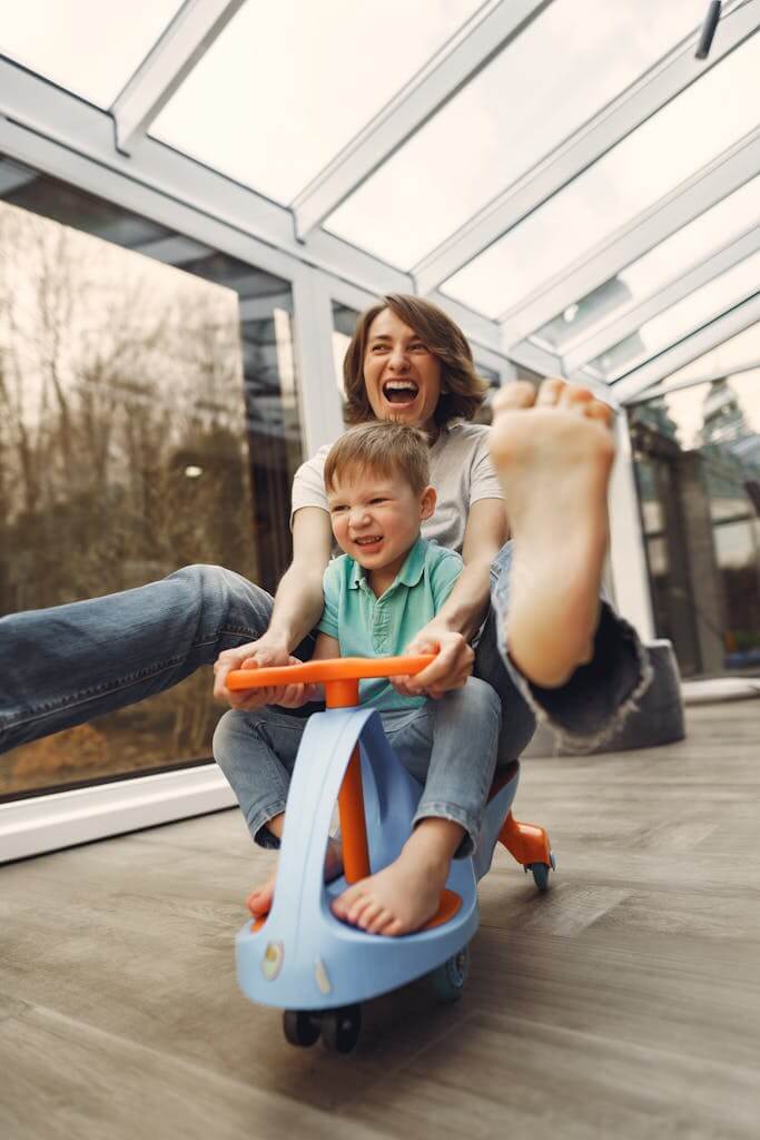 A joyful moment of a mother and son playing indoors on a toy car. Determining whether your feelings are due to overwhelm or ADHD can help improve your relationship with your family. Enjoy time with your kids without feeling exhausted all the time. Therapy for Overwhelmed Moms in NC and SC.