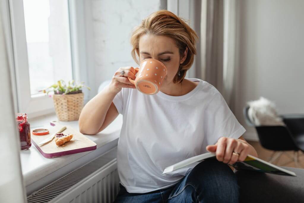 Overwhelmed woman was distracted and finally finding time to sit down and drink your coffee. Therapy for Overwhelmed Moms and ADHD Therapy provided in North Carolina and South Carolina. 