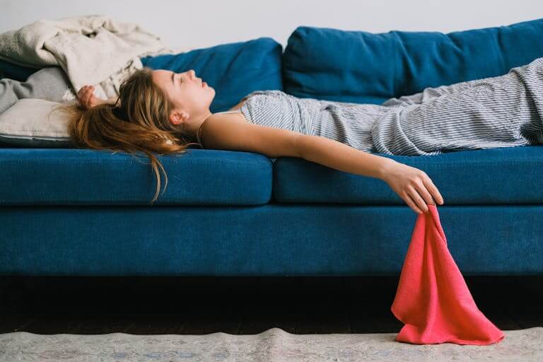 An overwhelmed woman taking a break on the couch. Online Therapy for Overwhelmed Moms can help you determine if it's overwhelming stress or if it's other mental health factors contributing to your exhaustion. If you're in North Carolina or South Carolina reach out to begin Therapy for stressed out moms. Therapy is available state wide and in Charlotte, NC.