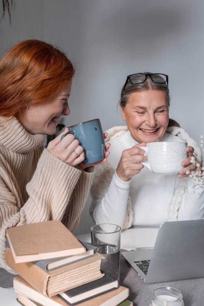 Women Bonding Over Coffee and Shared Memories | Brainspotting online in North Carolina | Brainspotting Charlotte NC | Brainspotting for Trauma South Carolina | 28209 | 27514 | 29910 A mother and adult daughter reconnect while chatting over coffee, reflecting the relational healing that can occur through Brainspotting therapy. Heal generational trauma with Brainspotting in Charlotte, NC, or online across the Carolinas.