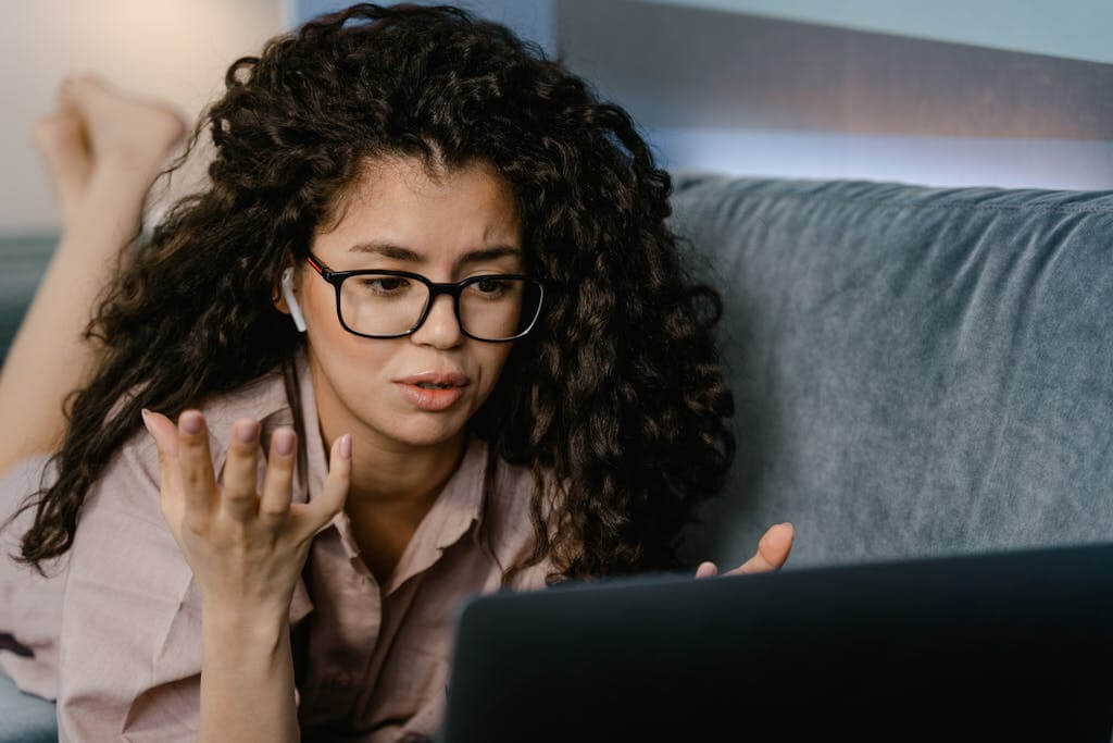 Woman wearing earbuds sharing her Brainspotting therapy experience during an online session. Brainspotting therapy for overwhelmed moms, trauma, anxiety, ADHD, and depression in North Carolina, South Carolina, Tennessee, and Illinois. Schedule your Brainspotting consultation today.