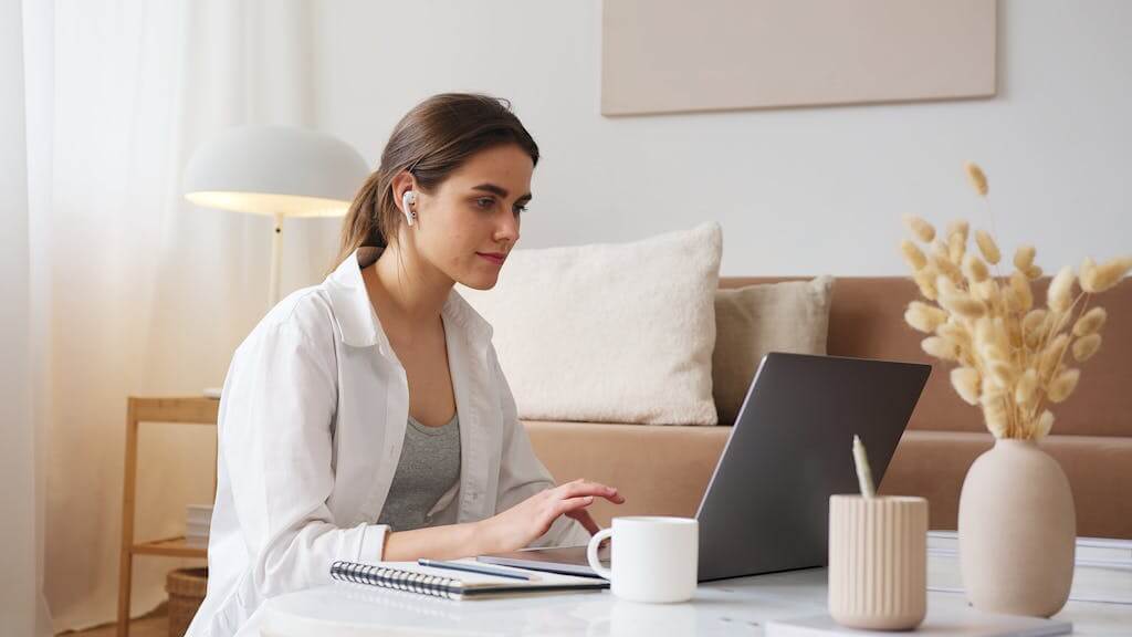 Woman wearing headphones during an online Brainspotting therapy session from her home in Raleigh NC | Therapy for overwhelmed moms | Therapy for depression