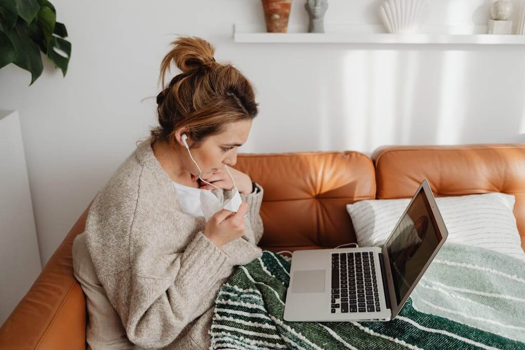 Woman with headphones engaged in an online Brainspotting therapy session from her home in Fayetteville NC | Trauma Therapy | Therapy for PTSD | Anxiety Therapy | Brainspotting Therapist in Fayetteville