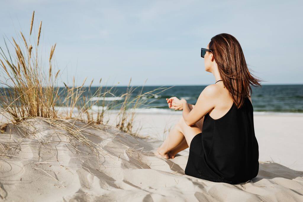 Woman sitting quietly at home in Wilmington NC before beginning online therapy with Mosaic Reflections | Brainspotting Therapy | Anxiety Therapy | Therapy for Trauma