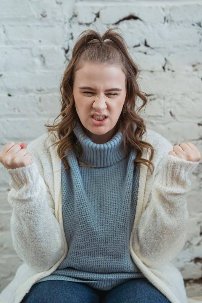 Woman clenching jaw | Brainspotting Therapy | Listening to your body Clenching jaw and fists | Bracing herself while listening to her nervous system | Therapy for trauma | Brainspotting in North Carolina